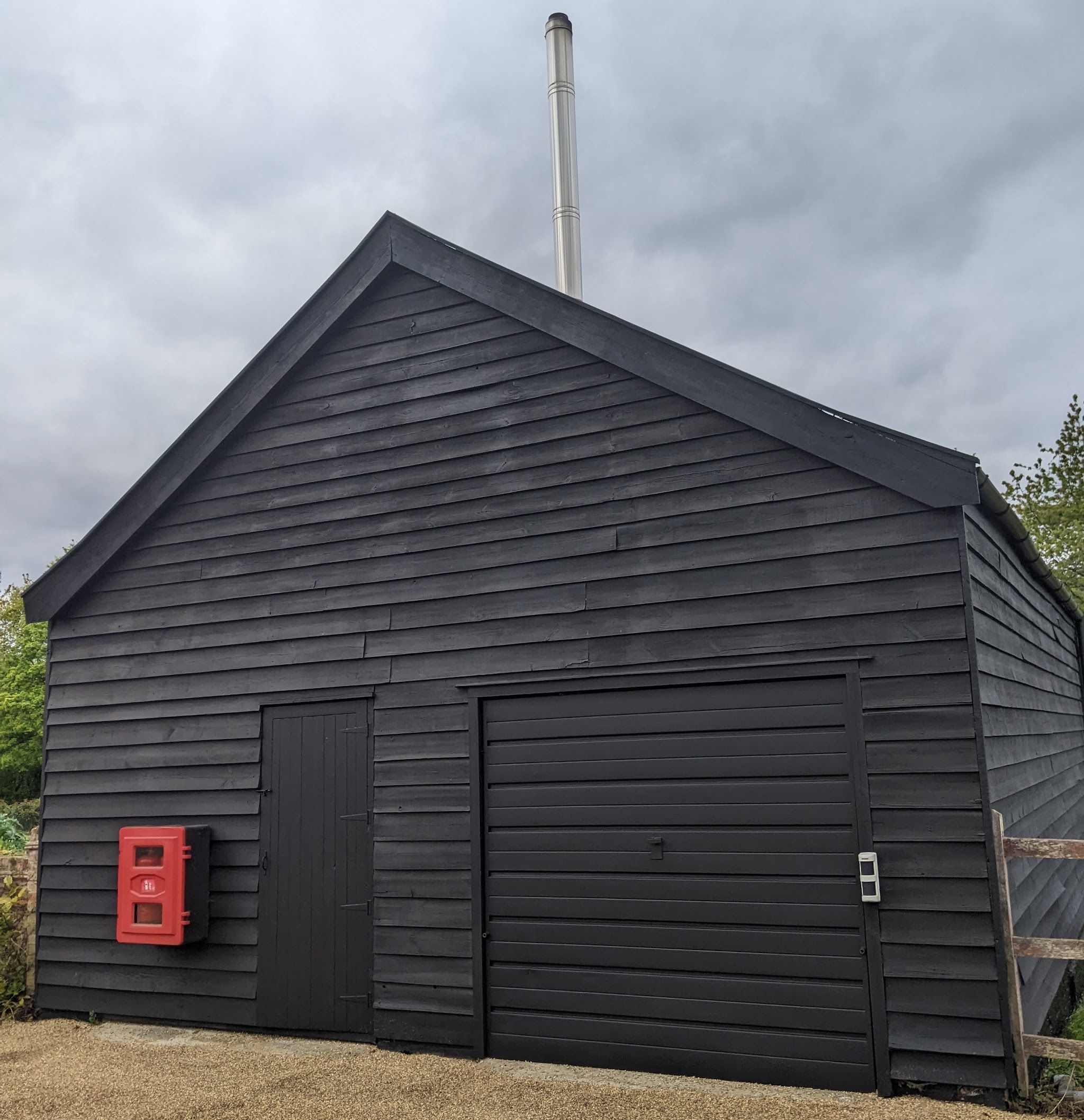 Black weatherboard barn exterior, freshly finished